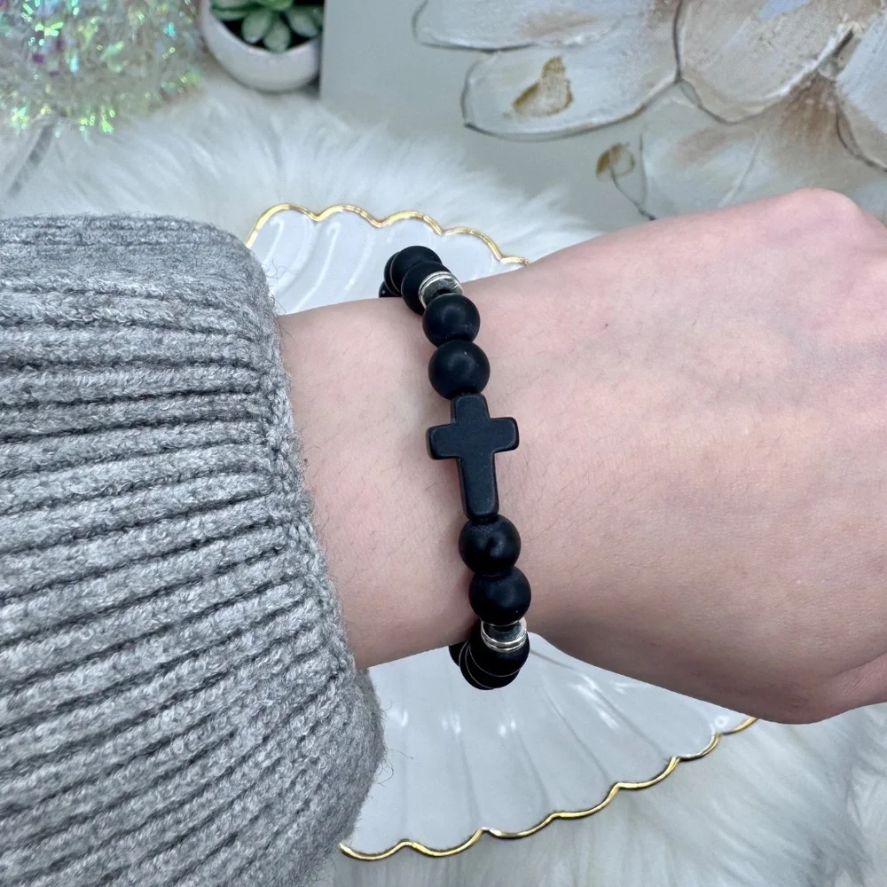 This elegant bracelet features smooth matte black beads paired with a bold black